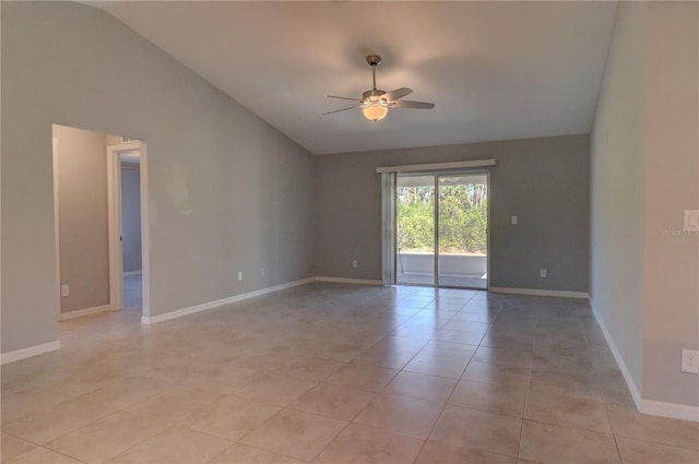 empty room featuring lofted ceiling, ceiling fan, and light tile patterned floors