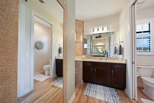 bathroom with hardwood / wood-style flooring, vanity, and toilet