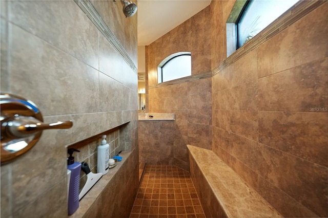 interior space featuring tiled shower, tile patterned flooring, and tile walls