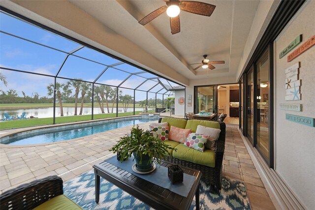 view of swimming pool featuring a water view, glass enclosure, ceiling fan, and a patio area