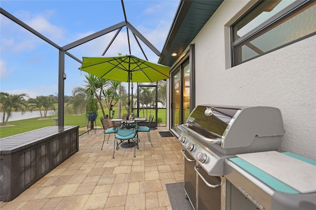 view of patio / terrace with a lanai, a water view, and grilling area