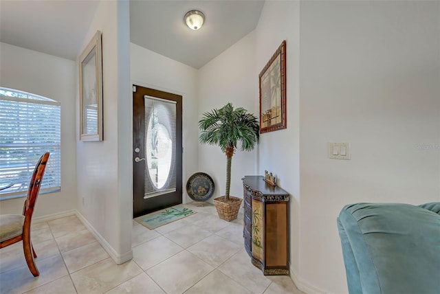 tiled foyer featuring plenty of natural light and vaulted ceiling