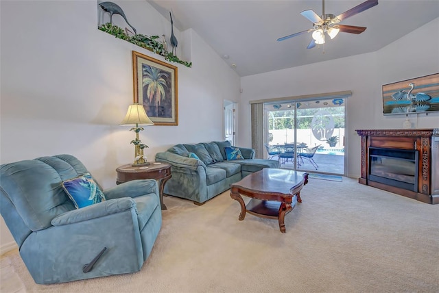 carpeted living room featuring ceiling fan and high vaulted ceiling