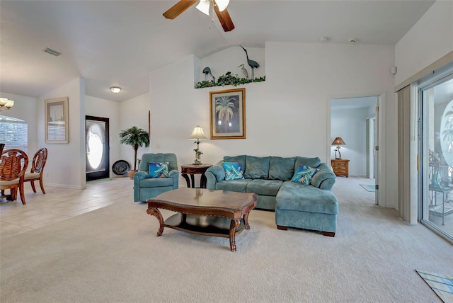 living room featuring ceiling fan with notable chandelier, light colored carpet, and lofted ceiling