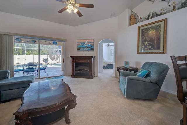 living room with ceiling fan, light carpet, and lofted ceiling