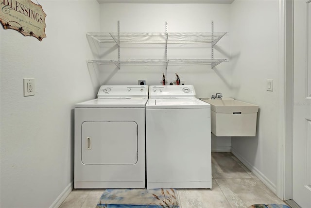 washroom with sink and washing machine and clothes dryer