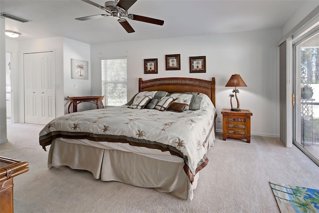 bedroom with ceiling fan, light carpet, access to outside, and multiple windows