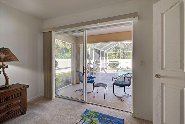 entryway with light colored carpet and plenty of natural light