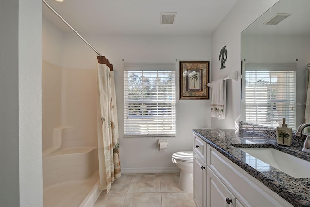 bathroom with tile patterned flooring, vanity, toilet, and plenty of natural light