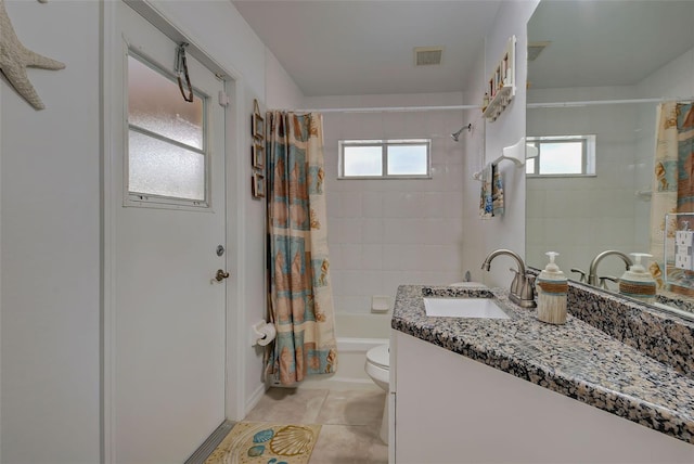 full bathroom featuring toilet, plenty of natural light, vanity, and shower / tub combo with curtain