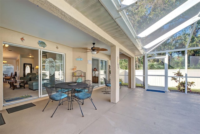 sunroom / solarium with plenty of natural light, ceiling fan, and lofted ceiling