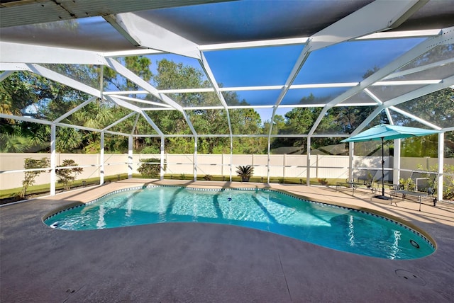 view of swimming pool featuring a lanai and a patio area