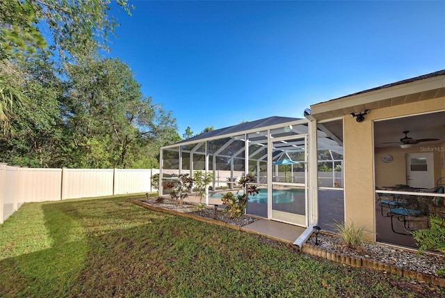 view of yard with a fenced in pool and a lanai