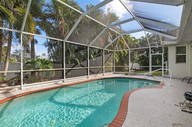 view of swimming pool with a lanai and a patio