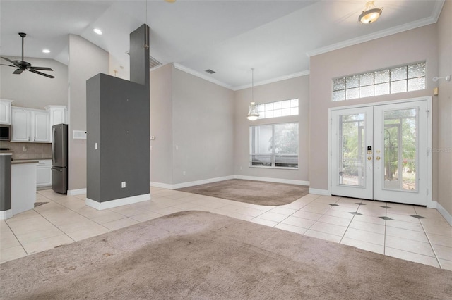 tiled entrance foyer with ceiling fan, crown molding, high vaulted ceiling, and french doors