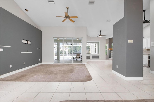 unfurnished living room with light colored carpet and vaulted ceiling