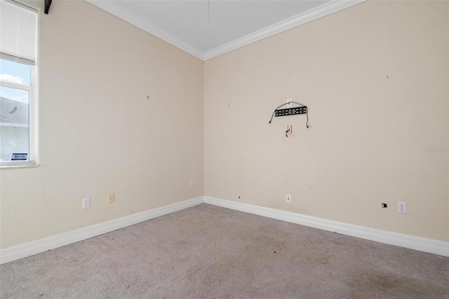 empty room featuring carpet, lofted ceiling, and crown molding