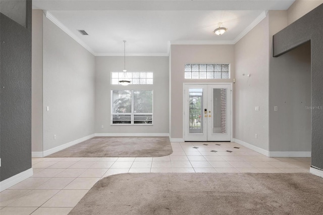 carpeted entrance foyer featuring crown molding and french doors