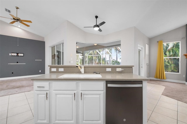 kitchen featuring light carpet, vaulted ceiling, white cabinets, and stainless steel dishwasher