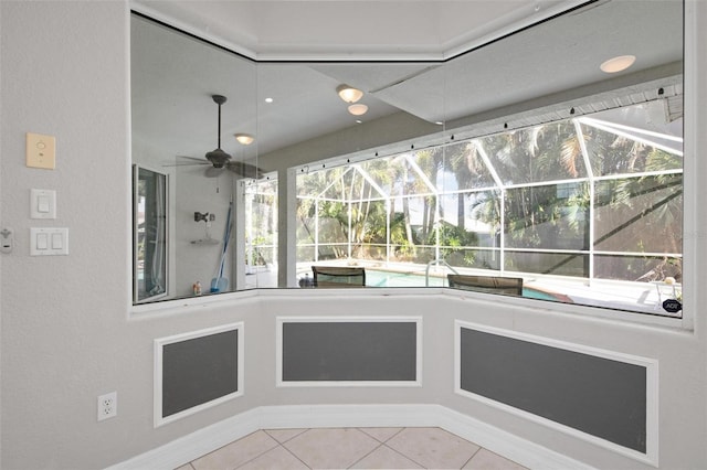 unfurnished sunroom featuring ceiling fan