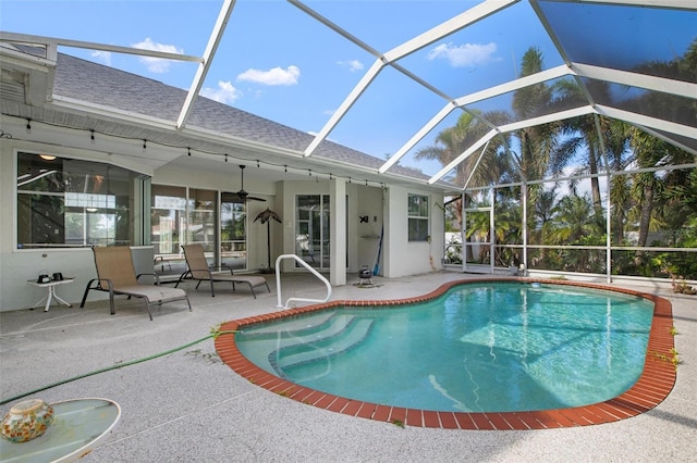 view of pool featuring a patio, ceiling fan, and a lanai