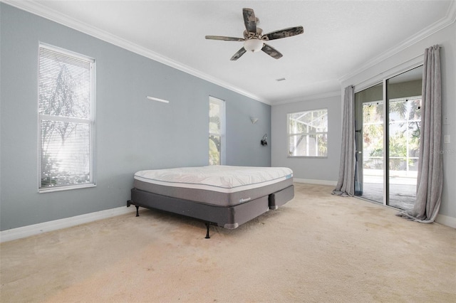 carpeted bedroom with ceiling fan, access to exterior, and ornamental molding