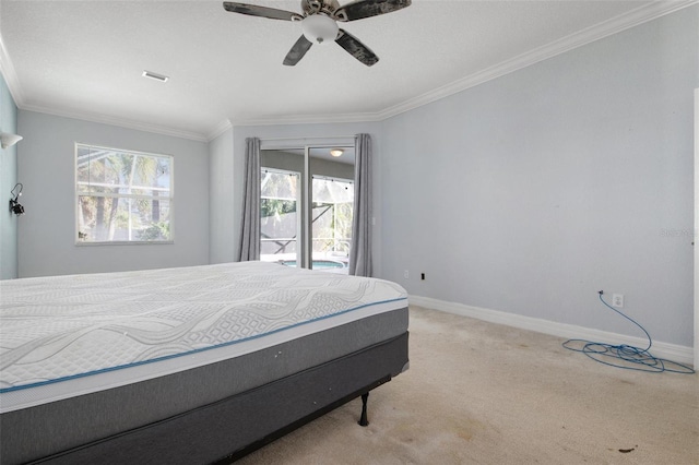 carpeted bedroom featuring multiple windows, ornamental molding, and ceiling fan