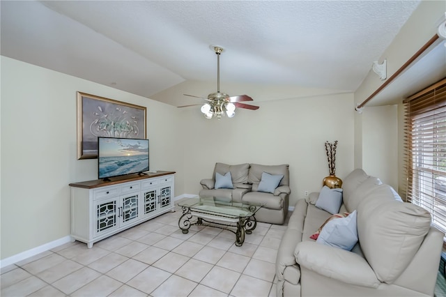 tiled living room with ceiling fan, a textured ceiling, and lofted ceiling