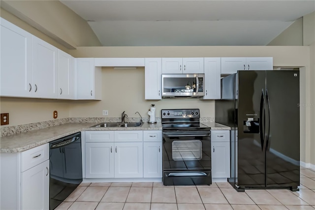 kitchen with sink, white cabinetry, black appliances, and lofted ceiling