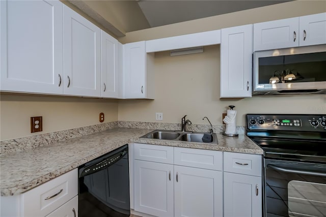 kitchen featuring white cabinetry, sink, and black appliances