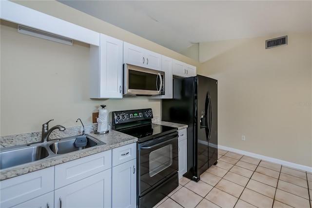 kitchen featuring white cabinetry, light tile patterned flooring, vaulted ceiling, black appliances, and sink