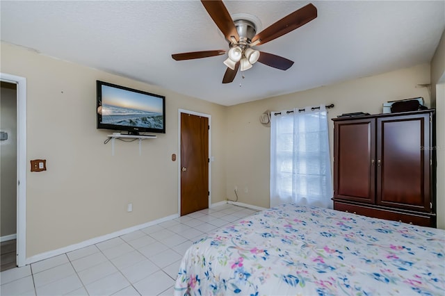 unfurnished bedroom with ceiling fan and light tile patterned floors