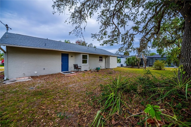 back of property featuring a lawn