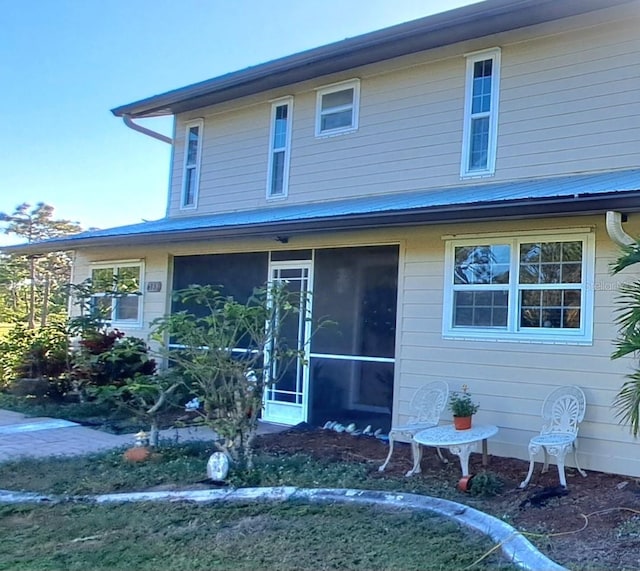 view of front of home with a sunroom