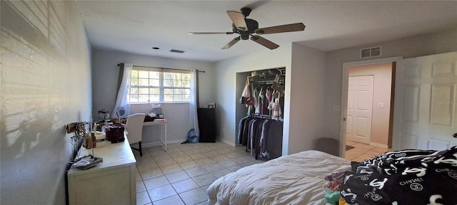 bedroom featuring light tile patterned floors, a closet, and ceiling fan