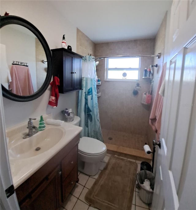 bathroom with tile patterned floors, curtained shower, vanity, and toilet