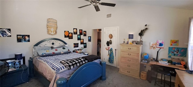 carpeted bedroom featuring ceiling fan and a towering ceiling