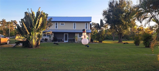 rear view of house with a lawn