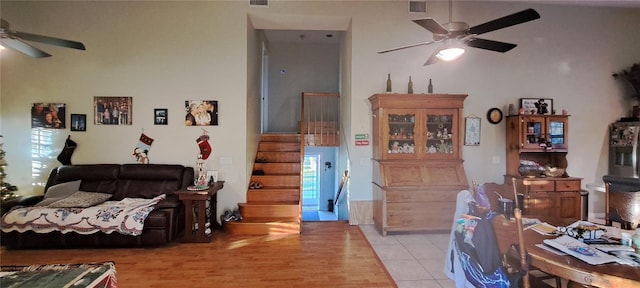 tiled living room featuring ceiling fan