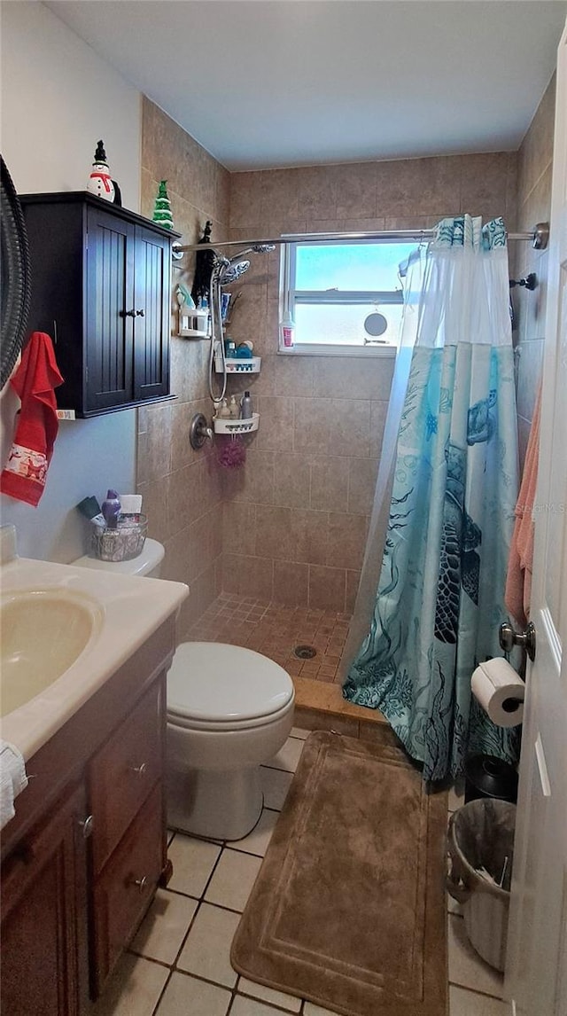 bathroom featuring tile patterned floors, vanity, curtained shower, and toilet