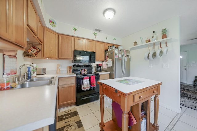 kitchen with black appliances, light tile patterned flooring, and sink