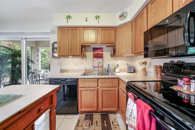 kitchen with black appliances, light tile patterned flooring, and sink