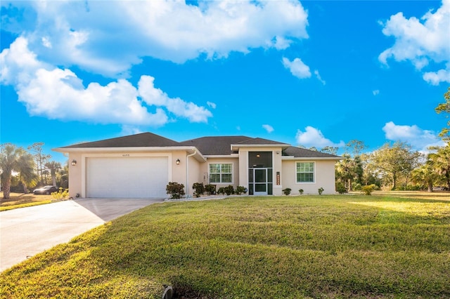 view of front of house featuring a garage and a front lawn