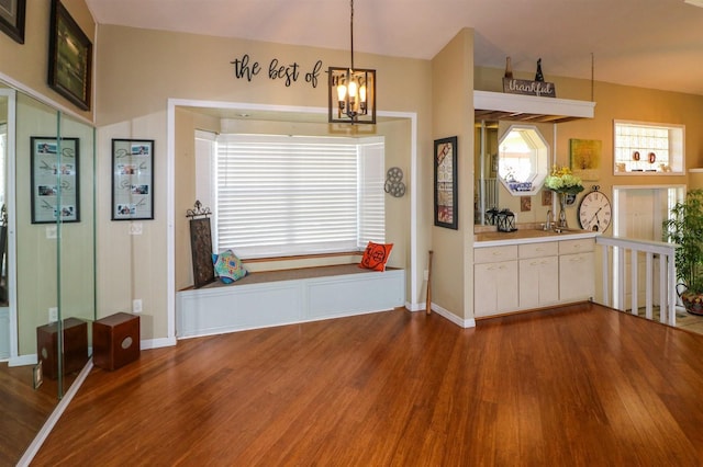 unfurnished dining area featuring hardwood / wood-style floors and a notable chandelier