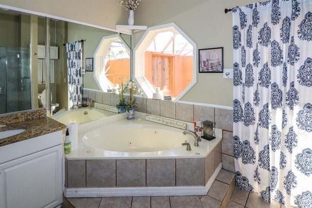 bathroom with tile patterned flooring, shower with separate bathtub, and vanity