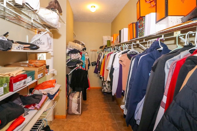 walk in closet featuring tile patterned flooring