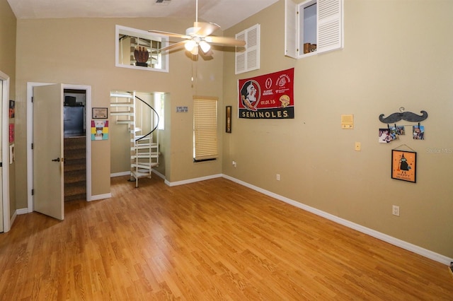 interior space featuring ceiling fan, high vaulted ceiling, and light hardwood / wood-style floors