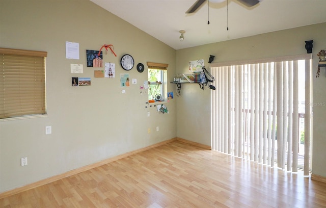 empty room featuring ceiling fan, light hardwood / wood-style flooring, and lofted ceiling