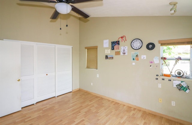 unfurnished bedroom with light hardwood / wood-style floors, ceiling fan, and lofted ceiling