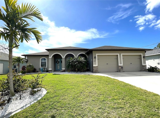 view of front of home with a front yard and a garage